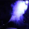 Smoke Machine Hire: A smoke machine is being used in a dark room.