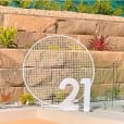 A circular white mesh backdrop is set up in front of a swimming pool.