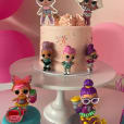 A cake with lol dolls on top of it displayed on a White Metal Cake Stand Hire.