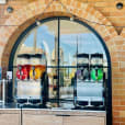 A Slushie Machine in front of a brick building, offering an impressive package of 240 drinks.