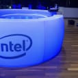 The intel logo is illuminated on a table.