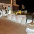 Rent a white outdoor lounge area with white chairs and tables for your next event, provided by Glow Couch Hire.