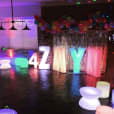 A vibrant birthday party with colorful balloons and glow cylinder seat hire options for added charm.