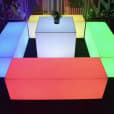 A set of colorful LED cubes glowing in a dark room.