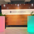 The entrance to a building with a colorful sign in front of it, featuring a vibrant Glow Square.