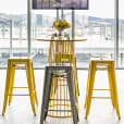 A yellow wire cocked table table inside of a bar area