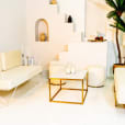 Gold coffee table and beige lounge
