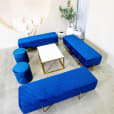 Gold coffee table hired with blue velvet lounge