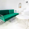 White Cross Coffee Table nest to an Emerald velvet lounge