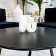 Close-up of the black round coffee table