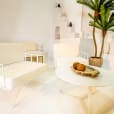 White round coffee table being hired next to a white lounge