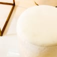 Close-up of a white velvet ottoman stool