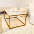 Four white ottoman stools next to a white coffee table