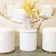 White ottoman stools set up for a party