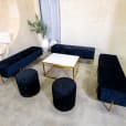 Black velvet ottoman stools next to an Ottoman lounge