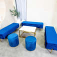 Navy blue ottoman stools next to an ottoman lounge