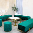 Green velvet ottoman stools next to an ottoman lounge