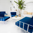 White wire lounge chairs with blue velvet cushions