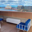 White wire lounge chairs with Sydney Harbour in the background