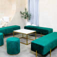 Emerald green velvet ottoman benches around a coffee table