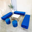 A lounge setting with navy blue ottoman benches