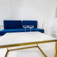 Navy blue wire sofa lounge behind a coffee table