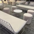 White Ottoman stools around a lounge setting