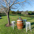 Our wine barrel with some Tolix tools next to a tree and Lake