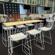 A white hairpin high bar table with timber top hired for a function