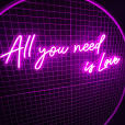 Purple neon sign that says: all you need is love