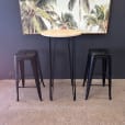 Our round cocktail table underneath a painting