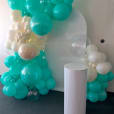 A balloon garland with aqua and white balloons