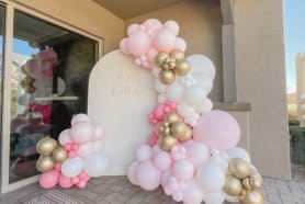 Pink and white balloons in front of our white balloon garland