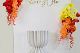 A yellow and red backdrop silk flower arrangement package