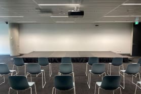 A stage in a room with chairs