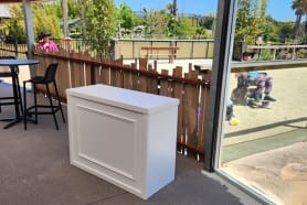 A wooden bar in an outdoor setting