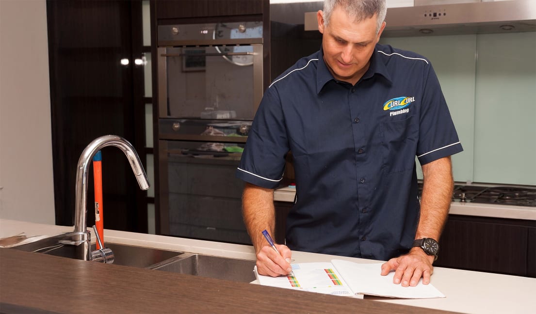 Shane from Curl Curl Plumbing performing a plumbing quote