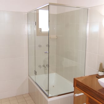 A small enclosed framed bath screen
