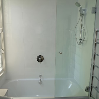 A glass bath screen on a small bath