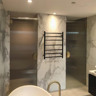 Patterned glass doors in a residential bathroom