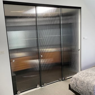 Patterned glass doors on a residential bathroom