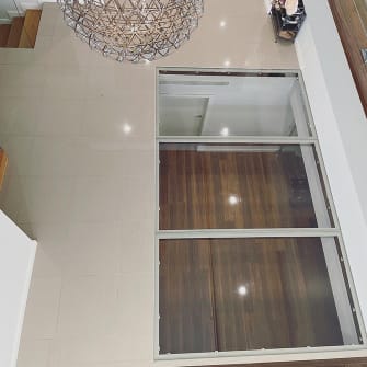 Looking down through glass flooring in a residential home