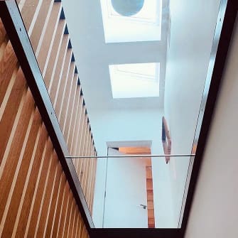A bottom view of a new glass floor installation