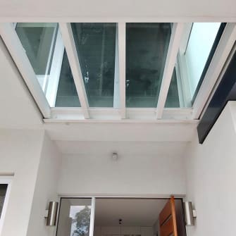 A glass roof above a front door entrance installed by Palmers Glass on a residential home