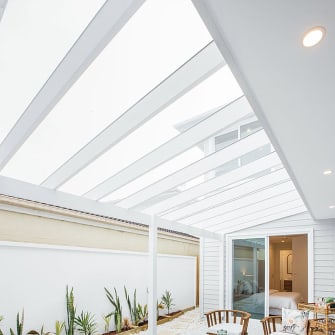 A slanting white glass roof on a residential home