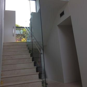 A glass wall next to a stairway in a home