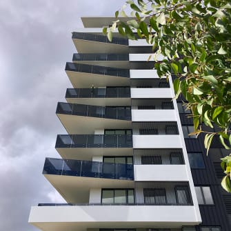 Tinted glass panels custom cut for balustrades and used on a large residential apartment block