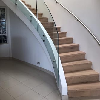Custom cut curved glass panels to use for staircase balustrading