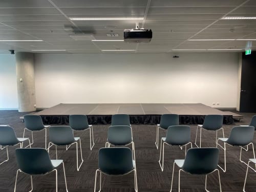 A stage in a room with chairs