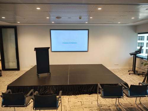 A black stage hired with a lectern for an event